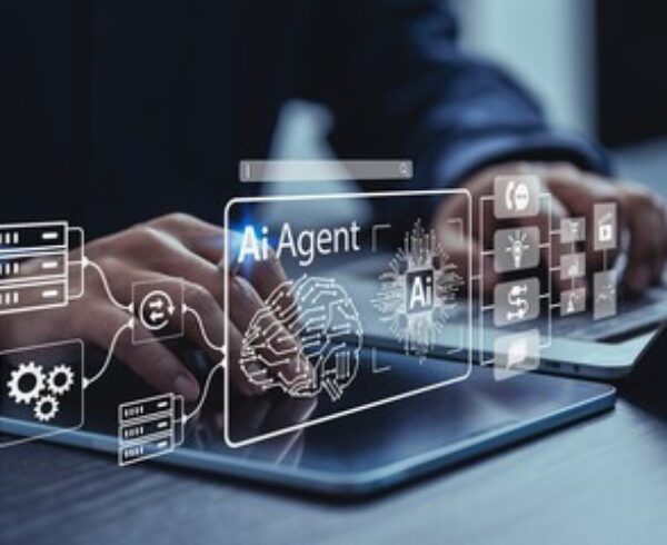 Business professional using a laptop with an AI agent interface.
